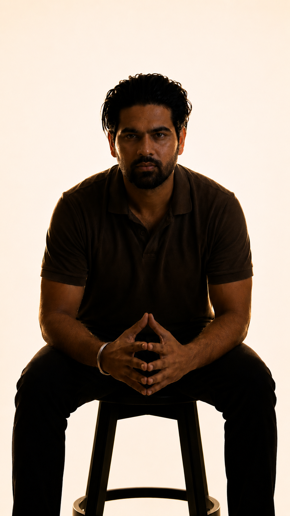 Akshay Raghav seated, backlit portrait